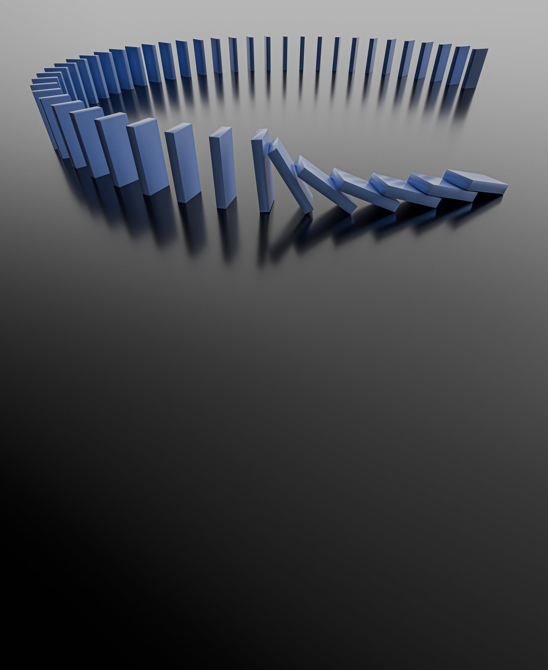 Falling domino blocks illustrating financial crisis with dark empty space for text